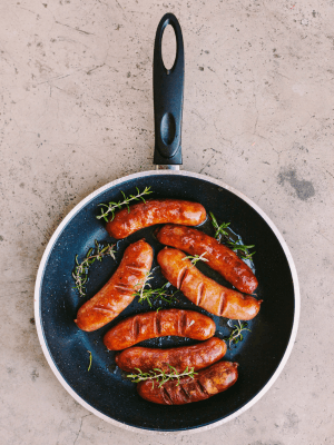 Fried sausages on a pan